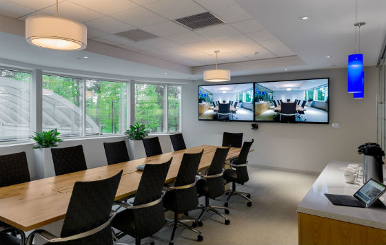 The main conference room with a hickory farmer's style conference table, video conferencing and glass wall.  Source: Rob Karosis Photography
