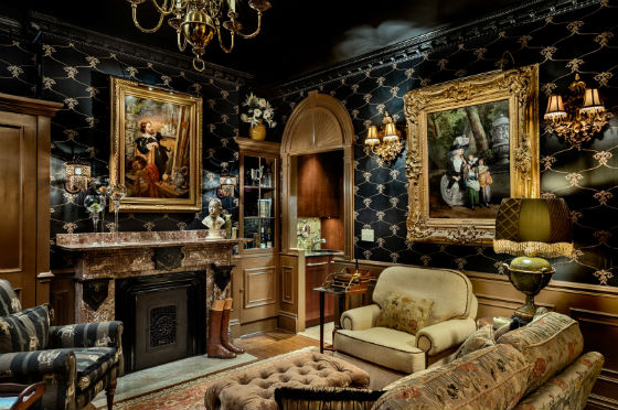 An overview of the living room.  The residence is used primarily in winter months and the design and finishings evoke a cozy and sumptuous nest.  The oil pain tings were located by the homeowners in a New Orleans gallery and range from 1577 to 1828. Source: Rob Karosis Photography